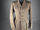 a woman ' s jacket and skirt are shown on a mannequin
