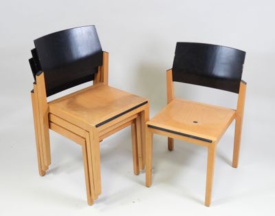 two wooden chairs and a small table on a white background