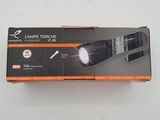 a box with a flashlight inside of it on a white surface