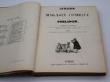 un livre ouvert sur lequel figure l'image d'une femme et d'un chien