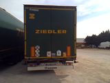 a truck that is parked in a lot with other trucks