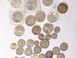 a lot of coins on the table next to a calculator and a calculator