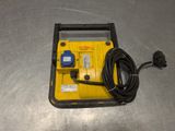 a close up of a yellow and black device on a metal surface