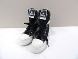 black and white sneakers with white laces on a white surface