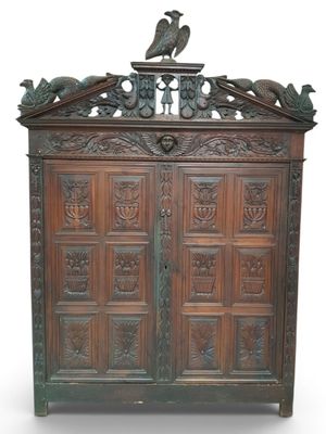 an old wooden cabinet with two birds on top of it