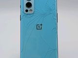 the back of a blue oneplus phone with a broken screen