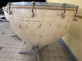 a large white drum sitting on a stand in a room