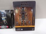 star wars action figures sit on a table in front of a box