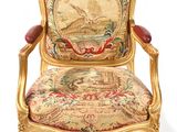 an image of a chair with a tapestry on the back of it