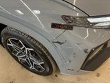 a close up of the front bumper of a silver car