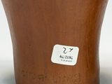 two brown vases sitting next to each other on a white surface