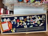 a box with a bunch of pins and magnets in it