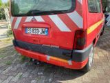 a red van that is parked on the side of the road