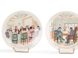 pair of porcelain plates with a picture of a group of people sitting at a table