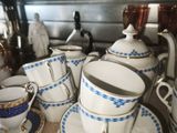 a lot of cups and saucers on a table