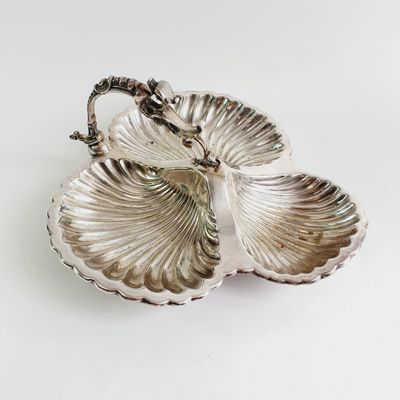 a silver plate with two leaves on it