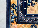 a blue and yellow rug with a design on it