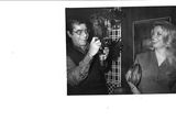 black and white photograph of a man and a woman in front of a mirror