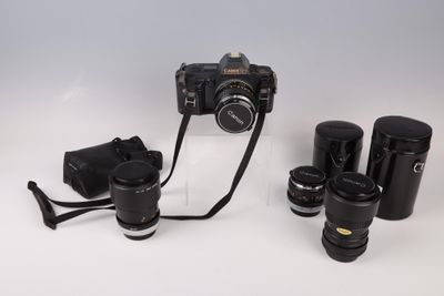 a camera and some other items on a white surface