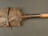 a wooden shovel with a leather handle on a table