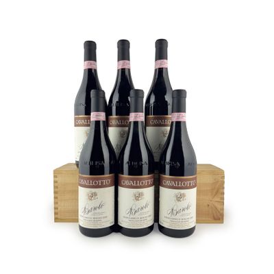 three bottles of red wine sit on a wooden crate