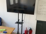 a large flat screen tv sitting on a stand in a room