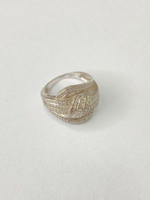 a close up of a silver ring on a white surface