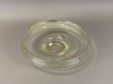 a clear glass bowl with a small amount of liquid in it