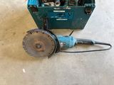 a blue box with tools in it sitting on the floor