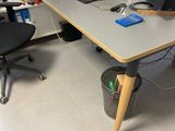 a desk with a computer and a chair in a room