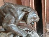 a statue of a cat on a rock in front of a door