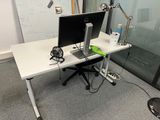 a desk with a computer and a monitor on it