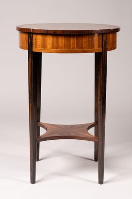 une table ronde avec un plateau en bois et une base en bois