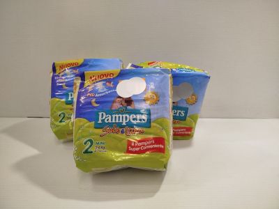 three packs of diapers sitting on top of a white counter