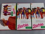 three barbie barbie dolls are on display in a box