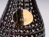 a black vase with a gold label on it