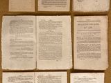 six pages of old papers are arranged on a table