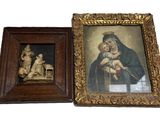 two framed paintings of a woman holding a baby and a man holding a child