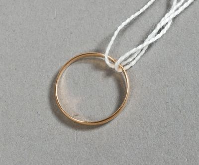 une photo d'une bague en or suspendue à un fil blanc