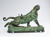 an image of a bronze statue of a lion on a rock