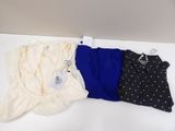 three women ' s tops on a white table with a polka dot pattern