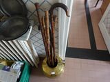 an umbrella that is sitting in a vase next to a radiator
