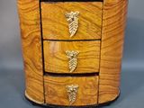 an image of a small wooden box with three drawers on it