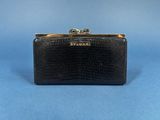a black purse with a gold clasp on it