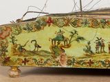 a small box with a painting on it sitting on a table