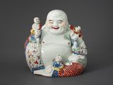 a statue of a laughing buddha with a bird on his arm