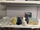 many cups and saucers on the shelves in the store