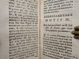someone is holding a book open to a page with a key in it