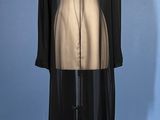 an image of a black and gold dress on a mannequin stand