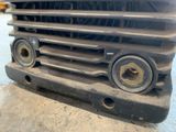 a close up of a truck grill with a lot of rust on it